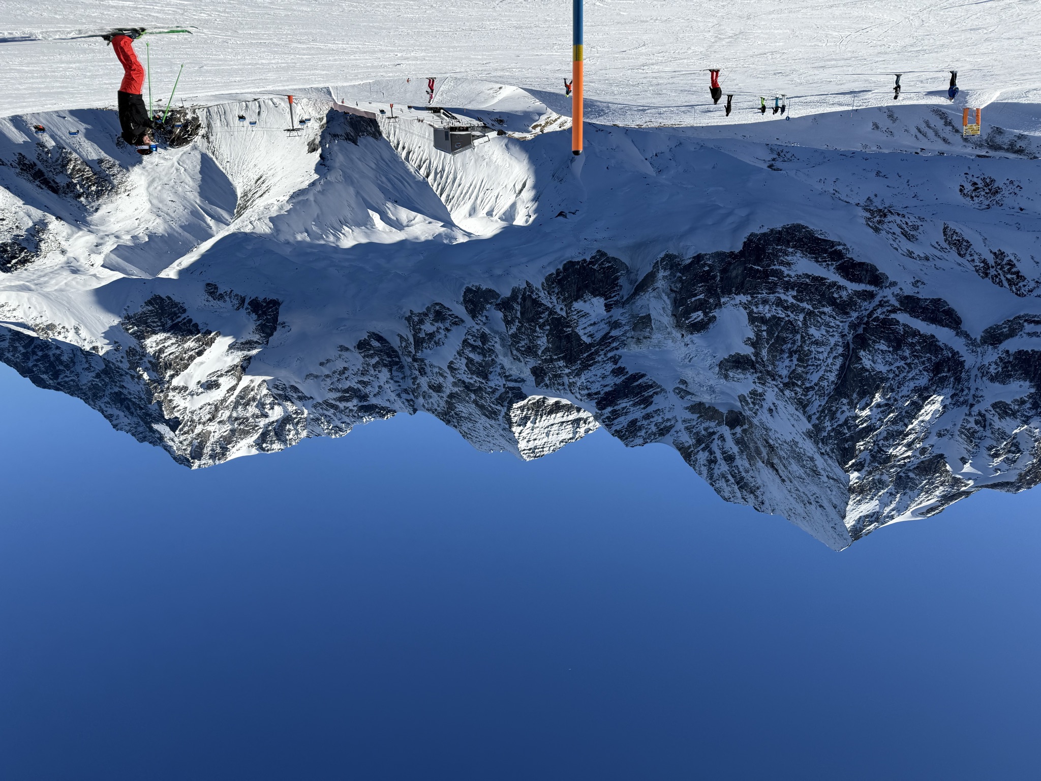 Piste skiers with the Ortler massif behind them in Sulden