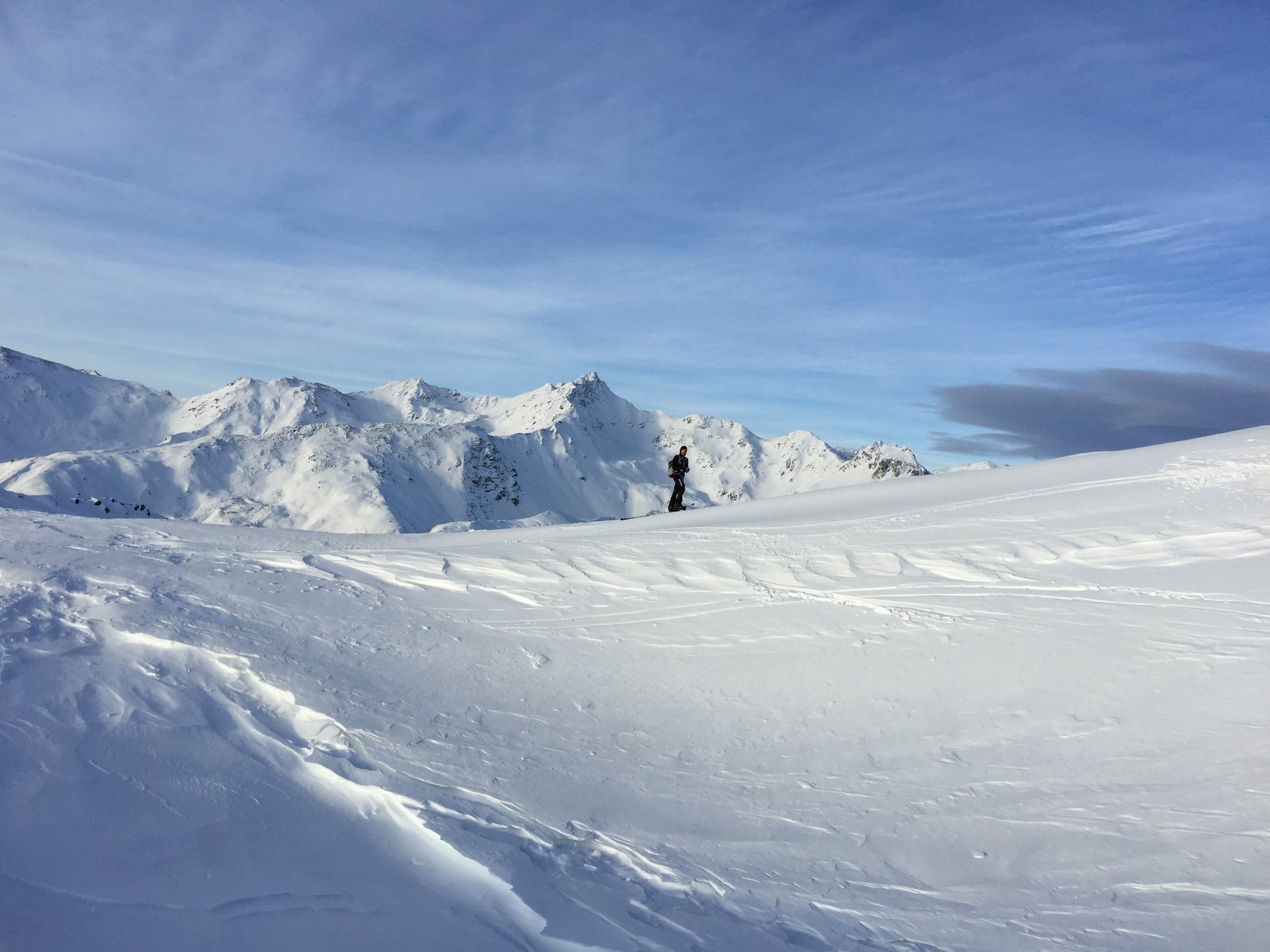 Skier on the slope under a blue sky
